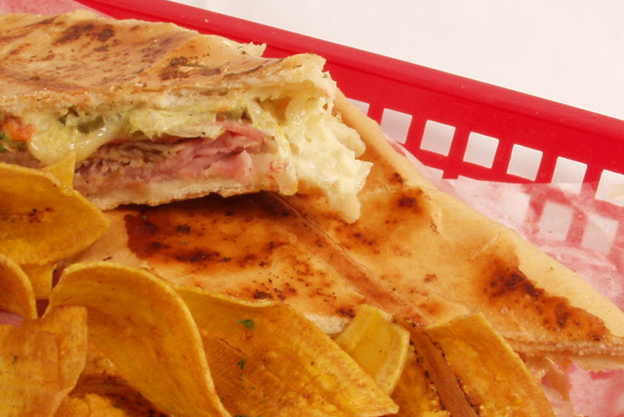 close up of cuban sandwich and plantain chips